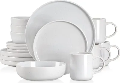 A stack of white ceramic plates, bowls, and mugs arranged on a white background.
