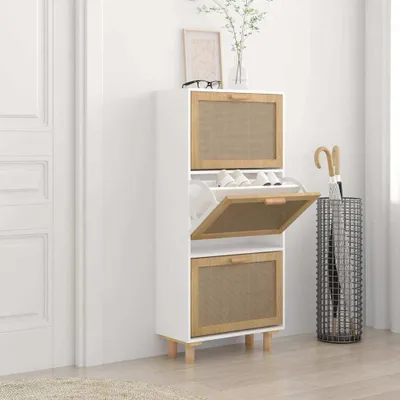 A white shoe cabinet with rattan accents is shown in a room with a white door and a light-colored rug.