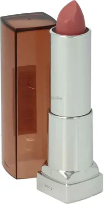 A lipstick tube with its cap off, standing next to its cap.