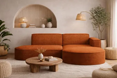 A modern living room with a sectional sofa, coffee table, and decorative elements.