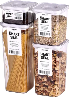 A set of four clear plastic food storage containers with white lids, filled with different food items like spaghetti, nuts, and grains. Labels on the containers indicate they are 'Smart Seal' products from Neoflam.