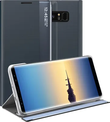 A dark blue flip case for a Samsung Galaxy Note 8 is shown, with the phone inside displaying a rocket launch image. The case is partially open, revealing the phone's screen and camera module.