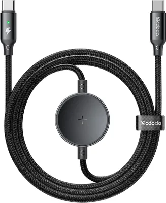 A black USB-C charging cable with a circular adapter in the middle, laid out in a loop on a white background.