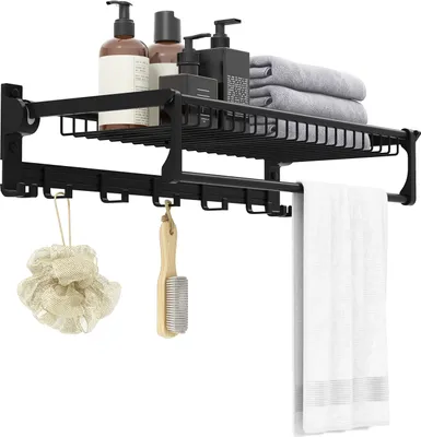 A black bathroom shelf with products and towels.