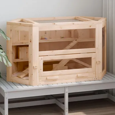 A wooden hamster cage is displayed on a white bench.