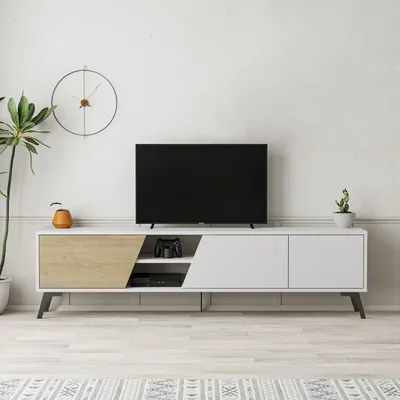 A modern TV stand with a television on top, placed in a living room setting.