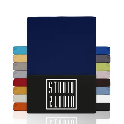 A stack of fabric swatches or samples in various colors, with a large navy blue swatch prominently displayed in the center. A black band with a white logo is visible at the bottom of the navy blue swatch.