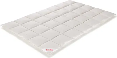 A white quilted comforter is shown from a diagonal angle on a white background.
