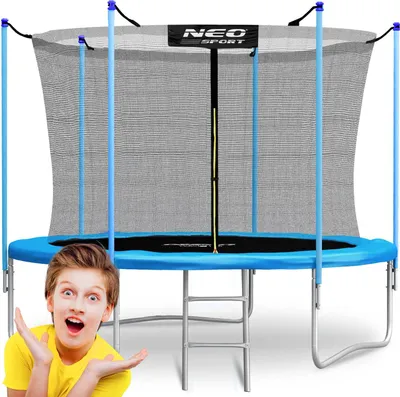 A boy is posing in front of a trampoline.