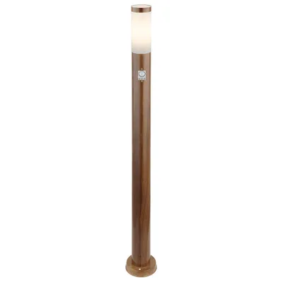 A single, tall, brown bollard light with a white frosted top.