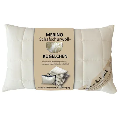 A cream-colored pillow with a label showing product details.