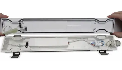 The image shows the inside of a disassembled LED wet room light fixture.
