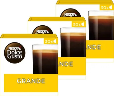 Three boxes of Nescafé Dolce Gusto Grande coffee capsules are stacked diagonally.
