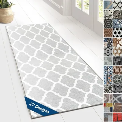 A runner rug with a quatrefoil pattern is laid out on a white wooden floor. To the right, a collage of 27 different rug designs is displayed.