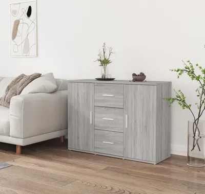 A gray sideboard with drawers and doors is placed in a living room next to a sofa.