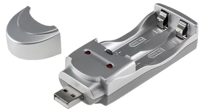 A silver USB battery charger with two slots for batteries and a detached cap.