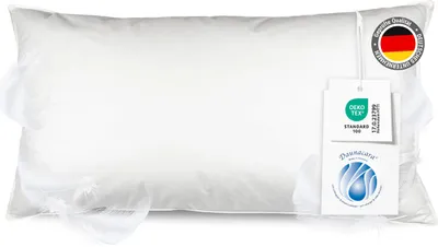 A white pillow with tags attached.