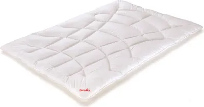 A white quilted blanket or comforter is shown lying flat on a white background.