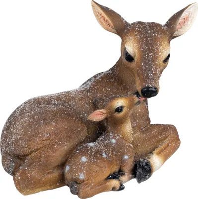 A decorative figurine of a mother deer and her fawn, covered in artificial snow.