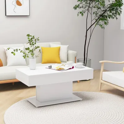A modern living room scene with a white coffee table, sofa, and armchair.