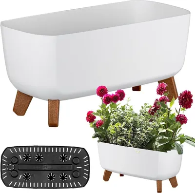 A white planter with wooden legs is shown, with a smaller planter containing flowers and greenery in the foreground, and a black insert in the bottom left corner.