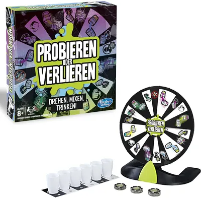 A board game box, a spinning wheel, shot glasses, and tokens are displayed together.