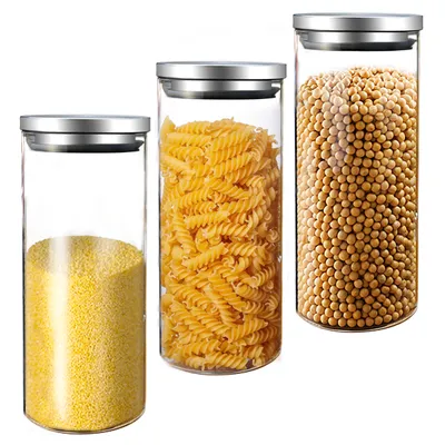 Three glass storage jars with silver lids, filled with different food items, are arranged on a white background.