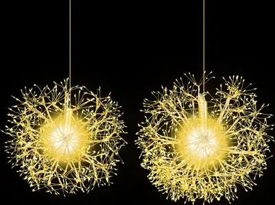 Two illuminated dandelion-shaped light spheres hanging against a black background.