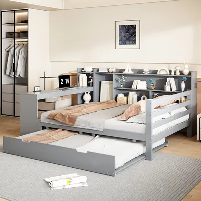 A bedroom scene featuring a gray daybed with a pull-out trundle bed, a built-in desk, and a bookshelf.