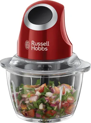 A red Russell Hobbs food chopper filled with chopped vegetables.