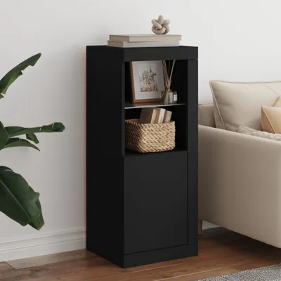 A black storage cabinet with a woven basket and books on display, positioned next to a couch and a plant.