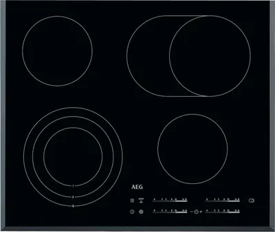 A top-down view of a black induction cooktop with four heating elements.