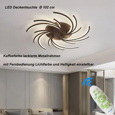 A modern LED ceiling light fixture with a swirling design, mounted on a white ceiling. The image also shows a remote control and a section of a room's interior.