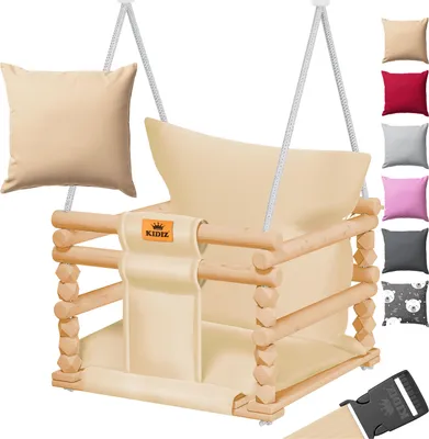 A baby swing with a wooden frame and beige fabric seat, shown with a separate beige cushion and a selection of colored cushions and a patterned fabric swatch on the right side.