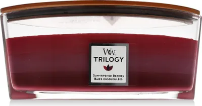 A close-up studio shot of a Woodwick Trilogy Sun Ripened Berries scented candle in a glass jar with a wooden lid.