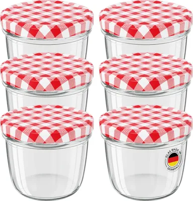 A set of six clear glass jars with red and white checkered lids, arranged in two columns of three.