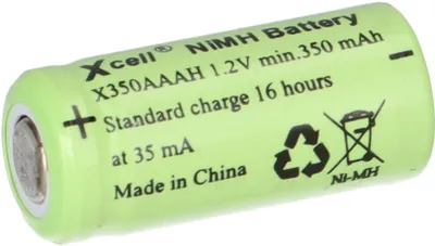 A single AAA battery with text and symbols printed on it, placed on a white background with some green shading.