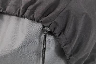Close-up of a drawstring closure on a gray fabric.