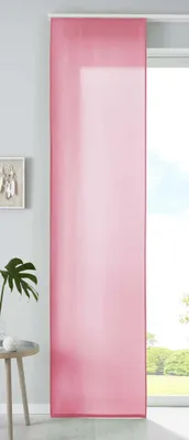 A pink sliding curtain hangs in front of a window, with a small table and plant to the left.