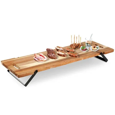 A wooden serving tray with various appetizers and snacks arranged on it, presented on a white background.