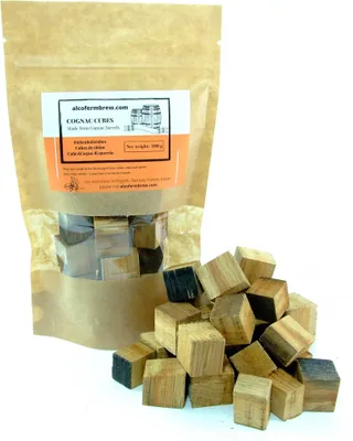 A bag of cognac cubes with some cubes spilled out in front of it.