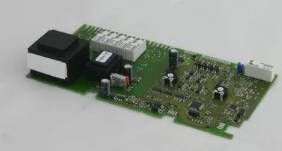 A circuit board with various electronic components, including transformers and capacitors, is shown on a white background.