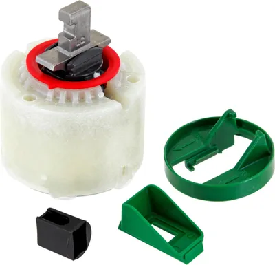 A set of plumbing faucet parts, including a cartridge and two green plastic guides, arranged on a white background.