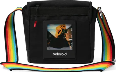 A black camera bag with a rainbow-colored strap and a Polaroid photo displayed on the front.