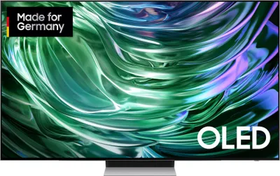 A Samsung Series 9 OLED TV displaying a colorful, abstract image. The TV is on a stand and has a 'Made for Germany' badge in the top left corner and 'OLED' text in the bottom right corner.