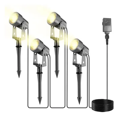 Four outdoor spotlights with stakes and a power adapter are arranged on a white background.