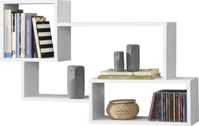 A white floating shelf unit with books, decorative owl figures, a woven basket, and CDs.
