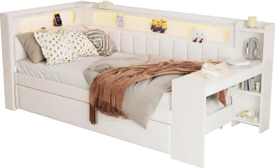 A white upholstered daybed with integrated shelving and LED lighting.