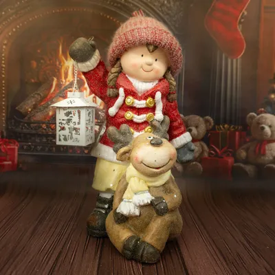 A Christmas-themed figurine of a girl holding a lantern and a reindeer, set against a fireplace background.
