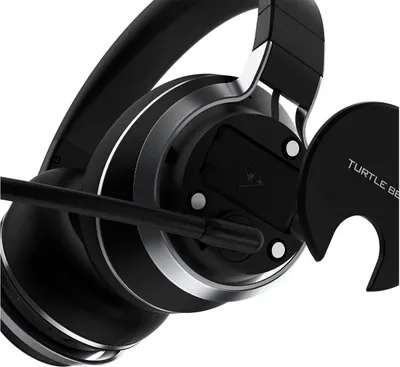 A close-up view of a black gaming headset, focusing on the ear cup and microphone.